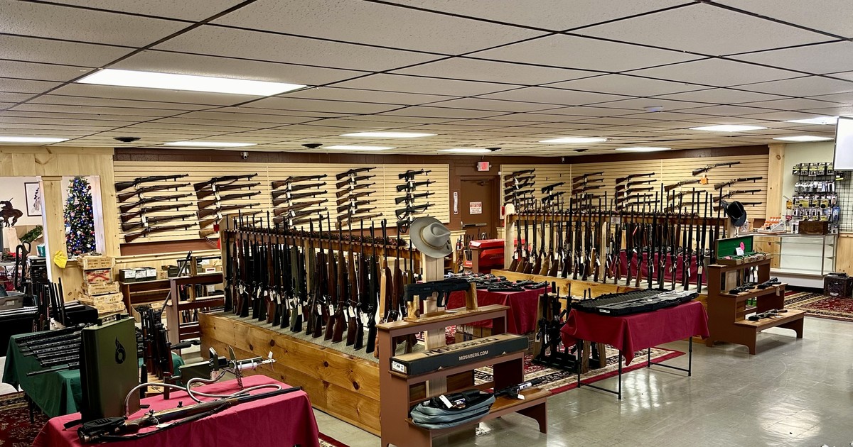 Military surplus rifles on wooden racks inside Tombstone Trading Company, Ware, Massachusetts